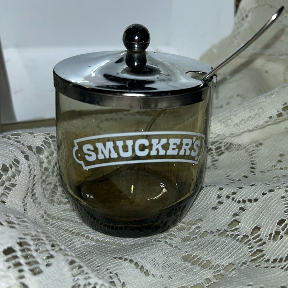 Smucker’s jelly jar with spoon.